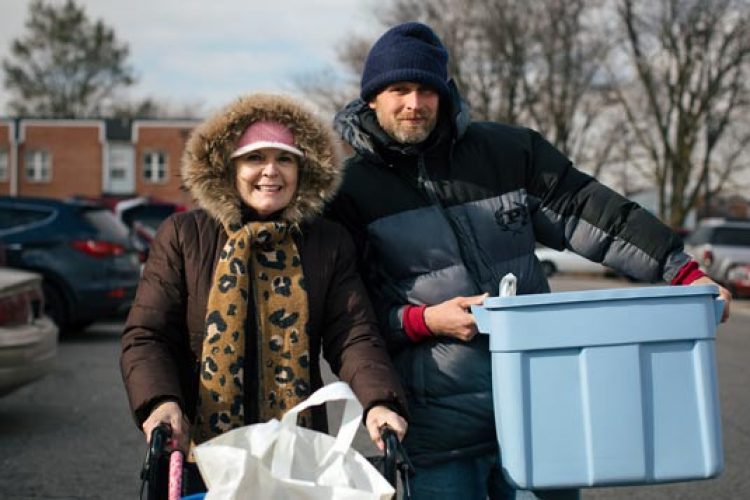 Woman and son leaving food pantry in winter