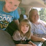 Woman and children in car at mobile pantry