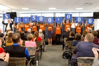 Nationwide employees hold placards showing the $1.5 million gift