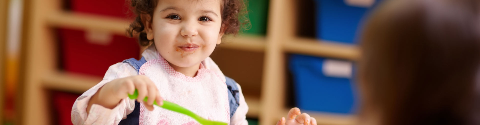 Toddler girl eating food