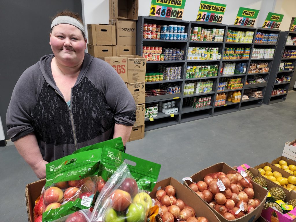 A woman shops for fresh produce and other groceries at Hawkeye Harvest, a Food Bank of Iowa partner pantry in Mason City.