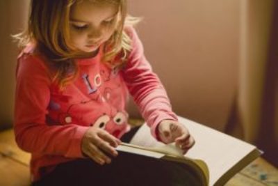 little girl reading a book