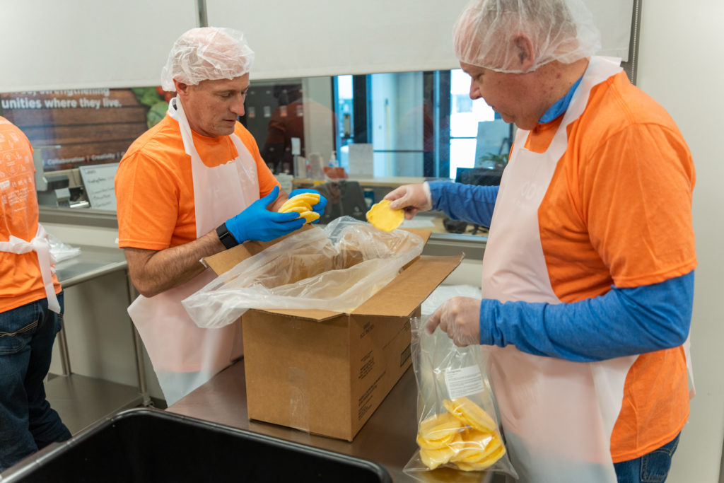 Volunteers packaging egg patties